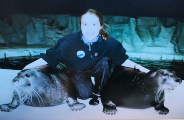 Caroline Conradi with two seals next to water