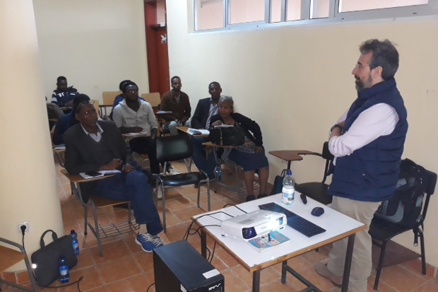 Javier presenting in front of 9 people seated at desks