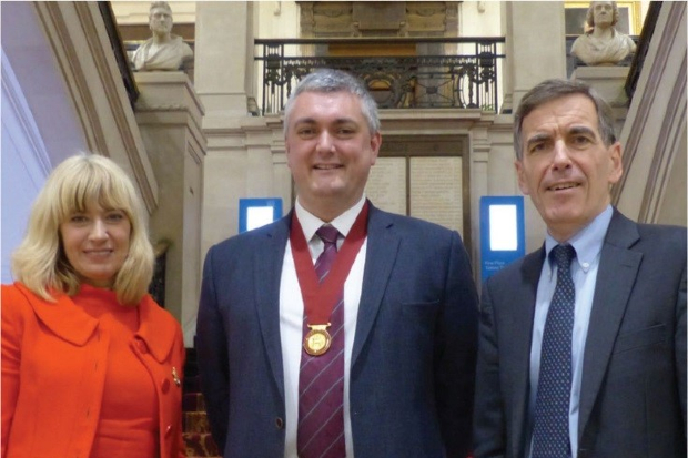 Three people standing on a staircase