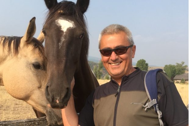 Milorad standing next to two horses