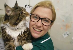 Alexandra Taylor, holding a large long haired cat.